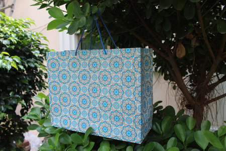 Colorful Paper Shopping bags are isolated on a green natural background. no plastic bags only eco-friendly bags.の写真素材