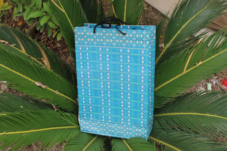 Colorful Paper Shopping bags are isolated on a green natural background. no plastic bags only eco-friendly bags.の写真素材