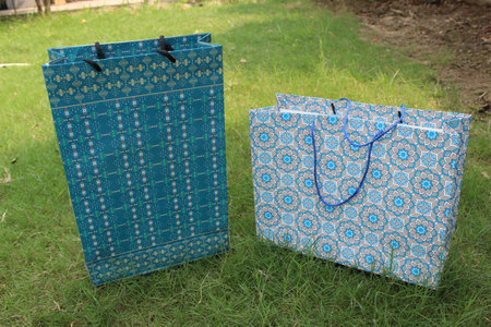 Colorful Paper Shopping bags are isolated on a green natural background. no plastic bags only eco-friendly bags.の写真素材