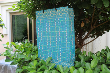 Colorful Paper Shopping bags are isolated on a green natural background. no plastic bags only eco-friendly bags.の写真素材