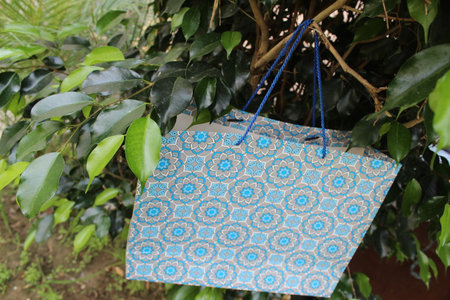 Colorful Paper Shopping bags are isolated on a green natural background. no plastic bags only eco-friendly bags.の写真素材