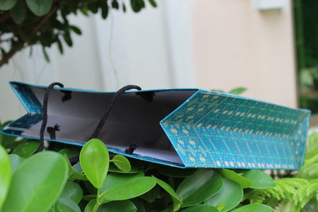 Colorful Paper Shopping bags are isolated on a green natural background. no plastic bags only eco-friendly bags.の写真素材