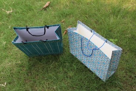 Colorful Paper Shopping bags are isolated on a green natural background. no plastic bags only eco-friendly bags.の写真素材