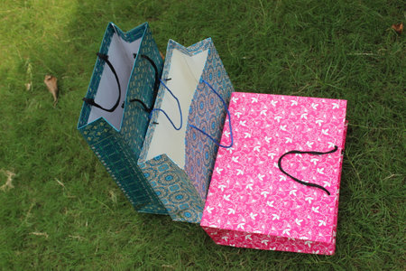 Colorful Paper Shopping bags are isolated on a green natural background. no plastic bags only eco-friendly bags.の写真素材