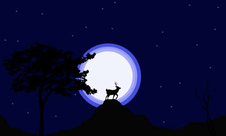 Deer standing over small mountain,with full moon background.の写真素材