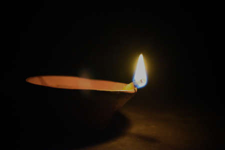 Traditional earthen lamps arranged in a beautiful pattern with colored rangoli (powder) designs on the occasion of Diwali festivalの写真素材