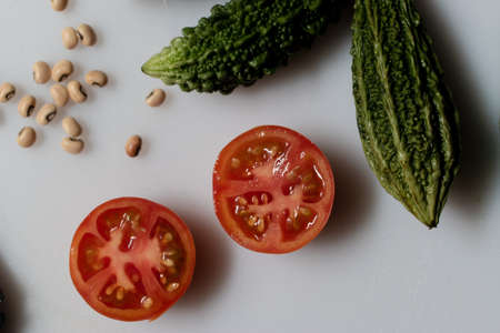 vintage style old salad with vegetables ingredients isolated on a plate.