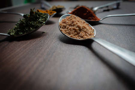 Indian Garam masala powder in bowl and it's ingredients colourful spices. Served over moody background. selective focusの写真素材