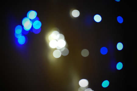 Colorful bokeh pattern formed on a black background by series of colorful led lights during a festival in India. Abstract light bubble bokeh.の写真素材