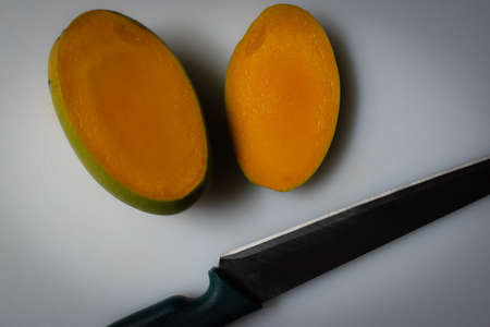 fruit cut by knife, the fruits with knife on plate .の写真素材