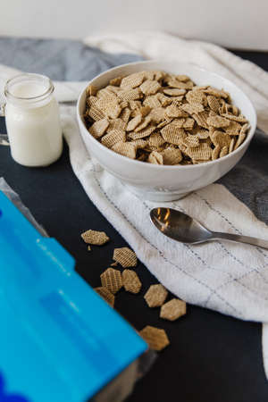 Cereal and milk bowl and spoon cereal box healthy cereal in white bowlの写真素材