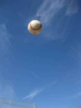 baseball flying through skyの写真素材