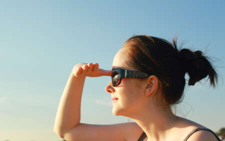 Girl staring into sunsetの写真素材