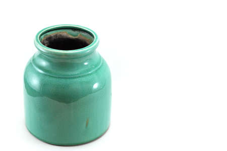 A photo of a turquoise vase on a white backgroundの写真素材