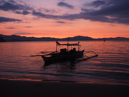 Traditional Philippine boat at sunsetの写真素材