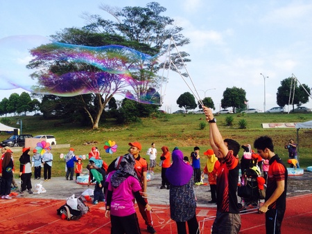 People having fun with giant bubbles