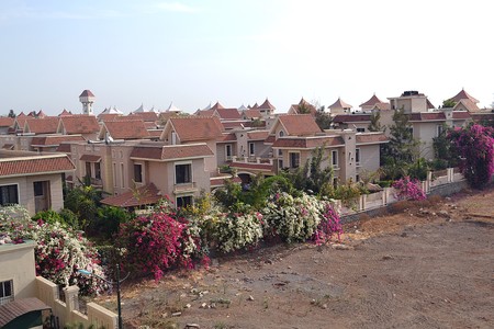 Residential complex surrounded by colorful flowersの写真素材