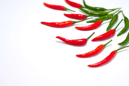 red and green chilli peppers isolated on a white backgroundの写真素材