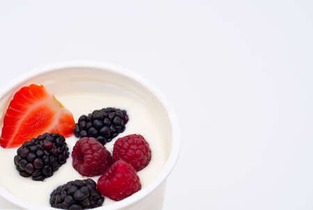 Berries dipped in natural greek yogurtの写真素材