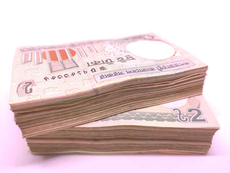 Stacks of two taka Bangladeshi banknotes close-up isolated on white backgroundの写真素材