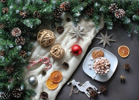 Frame composition of coffee with marshmallow, stars, fir tree, deer, candy canes, cookies, orange...