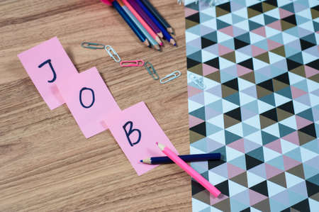 Wooden office table with different stationery, top view. Office worker workplace with pencils, paper, stapler and staplesの写真素材