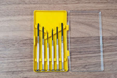 mini screwdriver set in a yellow box on the tableの写真素材