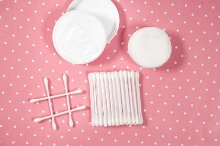 facials skin care. cotton pads and buds on the pink backgroung