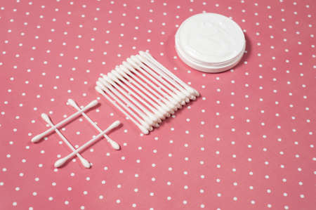 facials skin care. cotton pads and buds on the pink backgroungの写真素材