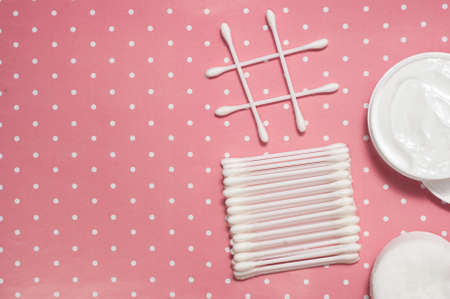 facials skin care. cotton pads and buds on the pink backgroungの写真素材