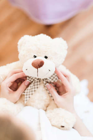bride tenderly holding a teddy bear which gave the beloved. view from above.の写真素材