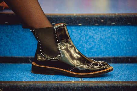 stylish shiny black shoes on the blue backgroundの写真素材