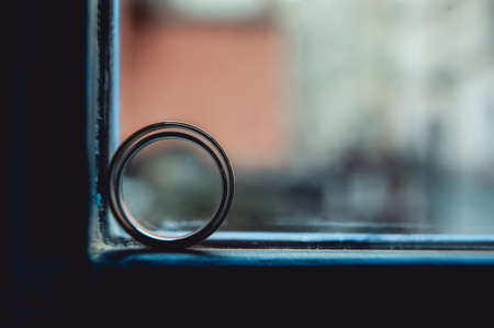 Wedding rings of gold. Ring in ring in a blue windowの写真素材