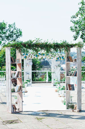 Retro wedding ceremony outdoors. wedding arch book and candle