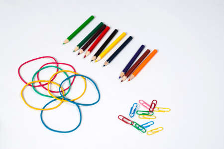 paper clip, color pencil and elastic on white paperの写真素材