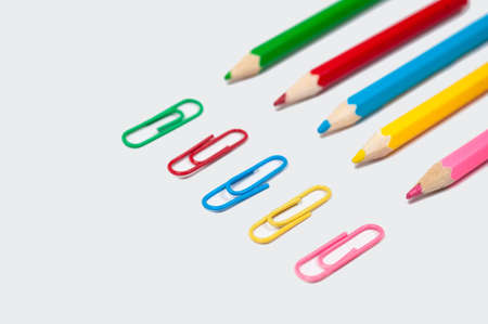 color pencil and paper clip on white paperの写真素材