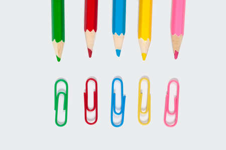 color pencil and paper clip on white paperの写真素材
