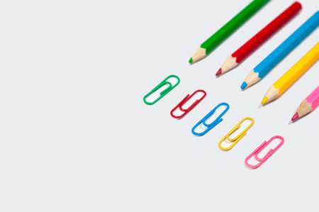 color pencil and paper clip on white paperの写真素材