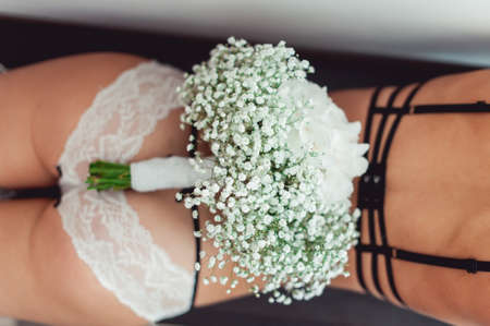 wedding bouquet of white gypsophila and hydrangea on the naked bride backの写真素材
