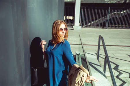 Happy red haired lady in the cityの写真素材