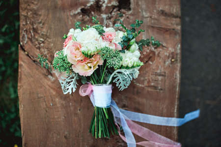 luxury bridal bouquet of white flowers on a wooden boardの写真素材