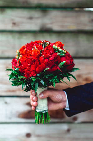 luxurious wedding bouquet made of red peony and rosesの写真素材