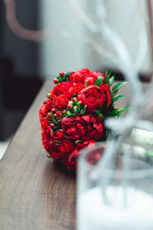 luxury bridal bouquet made of red roses and peonyの写真素材