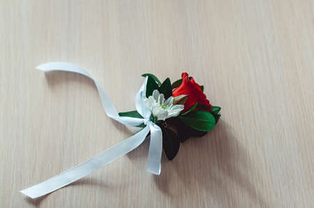 little wedding boutonniere with roses with white ribbonの写真素材
