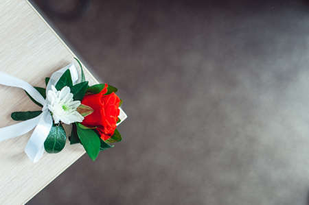 little wedding boutonniere with roses with white ribbonの写真素材