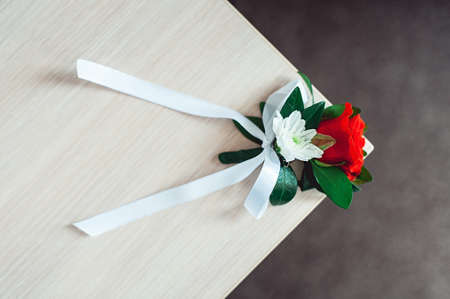 little wedding boutonniere with roses with white ribbonの写真素材