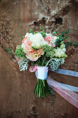 luxury bridal bouquet of white flowers on a wooden boardの写真素材