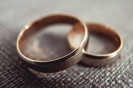 classic gold wedding rings on a textileの写真素材