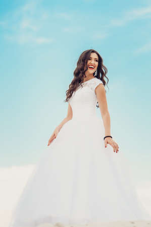 beautiful bride with long brown curly hairの写真素材