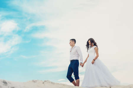 Newlyweds against blue skyの写真素材